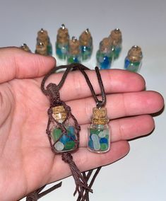 This tiny jar of seaglass is so cute! It comes in two styles, knotted and hook.  It can also double as the perfect rearview mirror hanger! The jar is sealed shut to prevent the cork from falling out (I tested this and the cork will fall out if necklace is worn when the cork is not sealed). However, if you are interested in having a jar you can open, please send me a message and I will leave it unsealed. Each item is handmade w/ ❤️ for the 🌎 Cork Bottle Necklace, Glass Jar Necklace, Easy Trinkets To Make, Mini Bottle Charms, Tiny Jar Crafts, Silly Crafts, Seaglass Crafts, Tiny Bottles, Jar Necklace