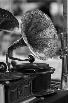 an old phonograph sitting on top of a table next to other musical instruments