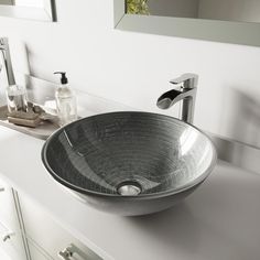 a bathroom sink sitting on top of a white counter