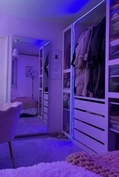 a bedroom with purple lighting and white furniture