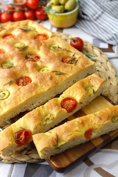 bread with tomatoes and olives on a cutting board