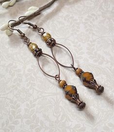 Looking for long Boho earrings?  These long Boho earrings have a rustic feel to them and were created using orange Czech glass beads with a Picasso finish and a brown wash, tan Czech fire polished beads, copper accents, and oval antique copper connector rings.  Total length of earrings, including the ear wire, is approximately 3". Thank you for visiting The Lucie Collection! Bohemian Metal Linear Earrings, Diy Leather Earrings, Rustic Earrings, Copper Accents, Earrings Beaded, Buffalo Ny, Bohemian Earrings, Copper Earrings, Leather Diy