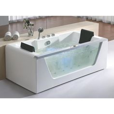 a white bath tub sitting on top of a wooden floor