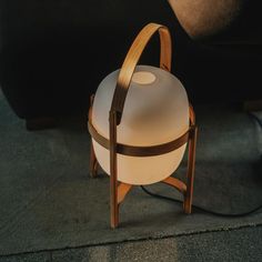 a lamp sitting on top of a wooden stand