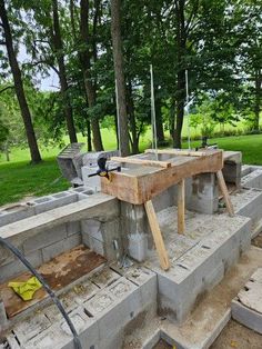 an outdoor kitchen being built in the woods