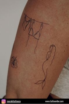 a woman's arm with a tattoo on it that has a line drawing of two women