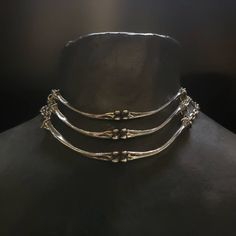 "Lead-free pewter cast chicken bone chokers. Each bone bar is 4\" x ¼\" Adjustable 14\" - 16\" See this listing for interchangeable pendant versions. https://www.etsy.com/listing/1204160736/bone-chokers-with-interchangeable?click_key=cc61314a71a59c20aee60a000413187b23f41fbe%3A1204160736&click_sum=a9392cb3&ref=shop_home_active_1&frs=1 Always ethically sourced bones. Nothing has ever been harmed for the purpose of our jewelry. All pieces are made-to-order despite the \"in stock\" number in the lis Pewter Casting Jewellery, Animal Bone Jewelry Wire, Bone Jewelry Aesthetic, Unique Adjustable Metal Choker, Nickel Free Punk Style Choker, Adjustable Oxidized Choker Jewelry, Gothic Silver Choker With Adjustable Chain, Metal Choker With Oxidized Finish, Unique Metal Clavicle Chain Choker