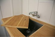 a kitchen sink made out of wood and metal