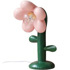 a pink flower lamp on a green stand with a light bulb attached to it's center