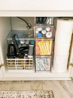 an open refrigerator door with various items in the bins and on the shelf next to it