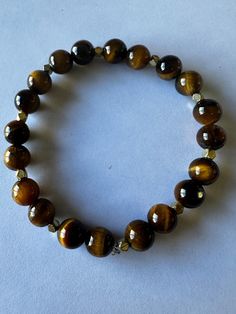 Tiger Eye 7 inch stretch bracelet 8mm stones  Tiger Eye represents promote Courage, Power and Protection. It is a stone of health and vitality. please contact me with any questions you have Health And Vitality, Tiger Eye Bracelet, Christmas Deals, Eye Bracelet, Stretch Bracelet, Crystals And Gemstones, Tiger Eye, Stretch Bracelets, Favorite Jewelry