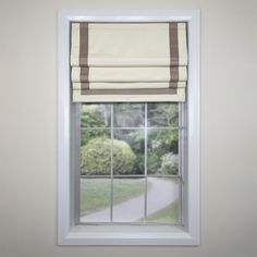 an open window with a white and brown striped roman blind on it's side