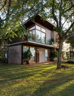 a large house sitting on top of a lush green field