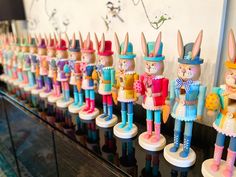 a row of colorful wooden toy soldiers on display