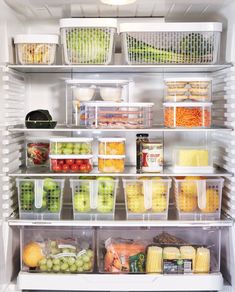 an open refrigerator filled with lots of food and storage containers on top of it's shelves