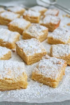 several pieces of cake sitting on top of a table covered in powdered sugar