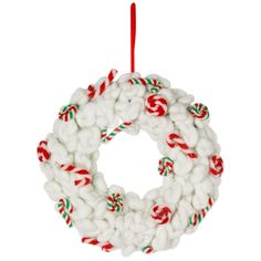 a white christmas wreath ornament hanging from a red and green cord with candy canes on it