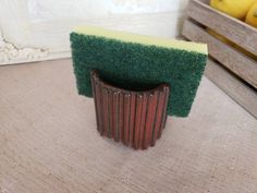 a close up of a brush on a table near some lemons and other fruit