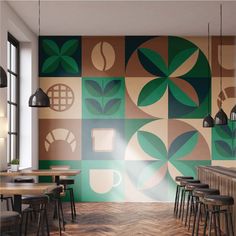 the interior of a coffee shop with tables and stools in front of a colorful wall mural