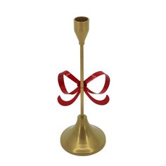 a gold candle holder with a red bow on it's end and a metal cup in the middle