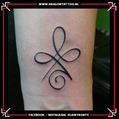 a tattoo on the foot of a person with an infinite knot in it's middle