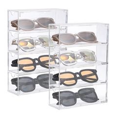 three clear acrylic shelves with sunglasses in them