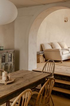 a living room filled with furniture and a wooden table