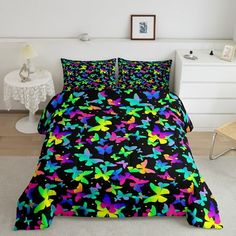 a bed with black and multicolored stars on it