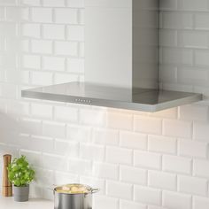 a stove top oven sitting next to a pot filled with food on a countertop