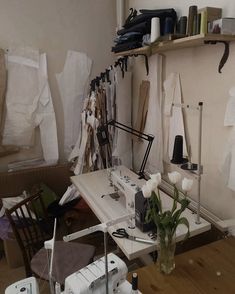 a sewing machine sitting on top of a table next to a vase filled with flowers