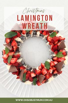 a christmas wreath made out of strawberries and chocolate on a plate with the words, christmas