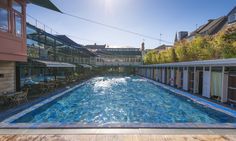 an empty swimming pool in the middle of a building with lots of windows on each side