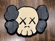 a rug with a skull and crossbones is on the floor in front of a wooden floor