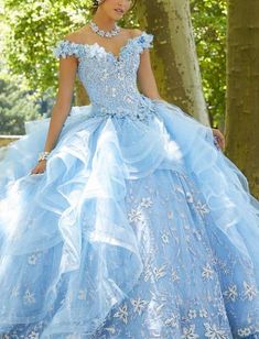 This Vizcaya prom dress showcases a sweetheart neckline and off the shoulder straps. The corset bodice is adjustable for the perfect fit. Ruffles overlay the tulle skirt giving it that fullness you desire. Shimmers of glitter appliques peek through the dress from head to toe. #promdresses2021 #promdresses #promdress #prom Sky Blue Quinceanera Dresses, Off Shoulder V Neck, Blue Sweet 16, Quincenera Dresses, Quinceñera Dresses, Blue Quince, Quinceanera Dresses Blue, Pretty Quinceanera Dresses, Quince Dress