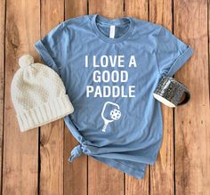 a t - shirt that says i love a good paddle with a hat on it