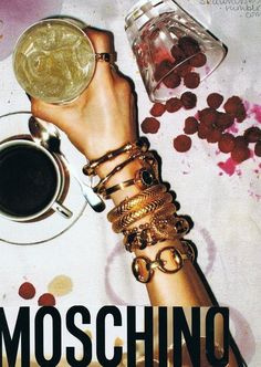 there is a poster with the words moschino and two cups of coffee on it