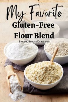 three bowls filled with flour sitting on top of a wooden table next to two spoons