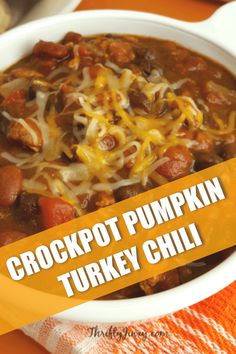 a bowl of crockpot pumpkin turkey chili on an orange napkin with the words crockpot pumpkin turkey chili