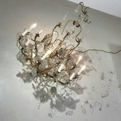 a chandelier that is on the floor with water droplets