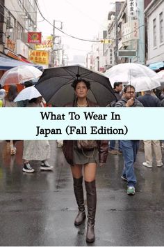 a woman walking down a street holding an umbrella over her head with the words what to wear in japan fall edition