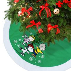 a christmas tree skirt with the image of charlie brown and snoopy on it in front of a green background