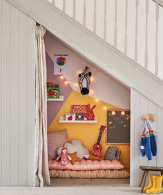 a child's bedroom with yellow walls and white stairs