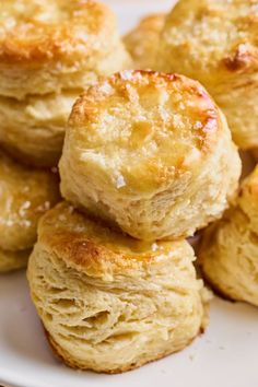 several biscuits stacked on top of each other on a white plate with powdered sugar