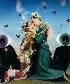 two people with hats and flowers on their heads, one is kissing the other's face