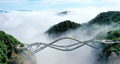 a bridge that is suspended above the clouds