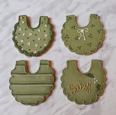 three baby bibs and one bib cookie