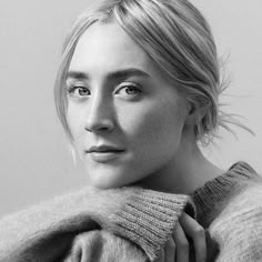 a black and white photo of a woman with blonde hair wearing a turtle neck sweater