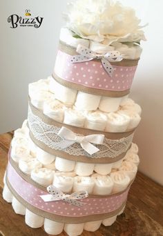 a multi layer diaper cake with white flowers on top