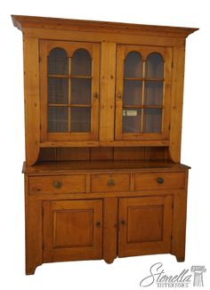 a wooden hutch with glass doors and drawers