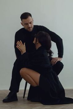 a man kneeling down next to a woman